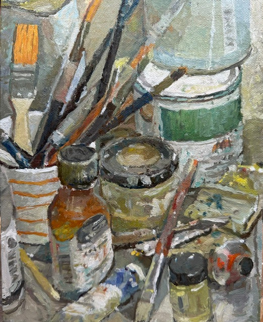 An oil painting depicting an artist's studio clutter with paintbrushes, paint tubes, jars, and cans.