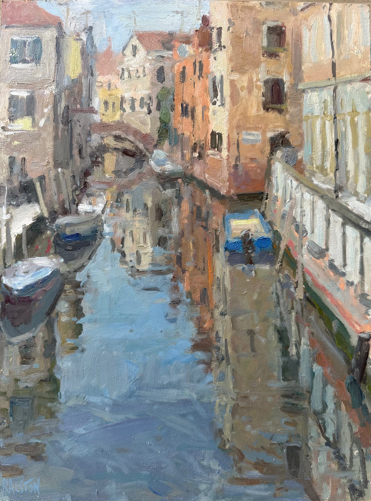 Reflections on the water in Venice with canal boats and a bridge, with light on the buildings