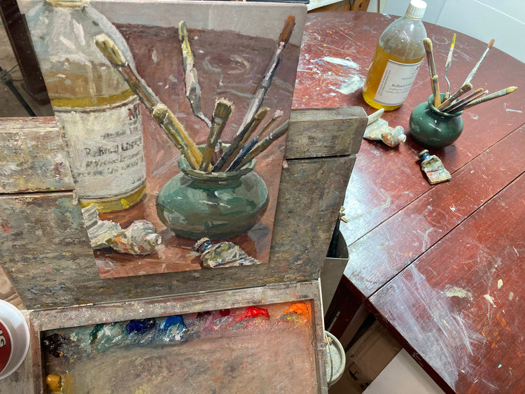 An oil painting of a still life of brushes and turpentine on a table by Adam Ralston