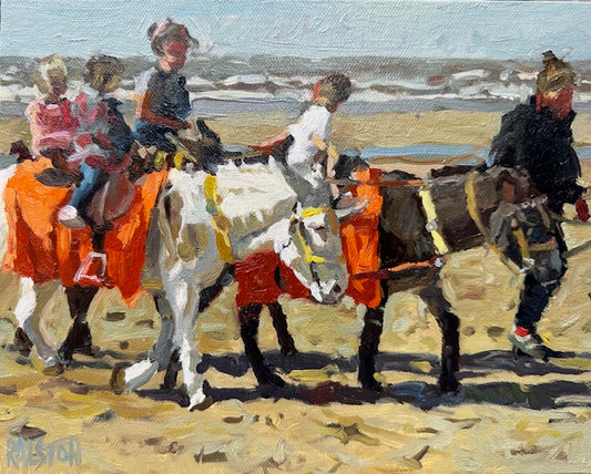 Children riding donkeys on a beach with a scenic background