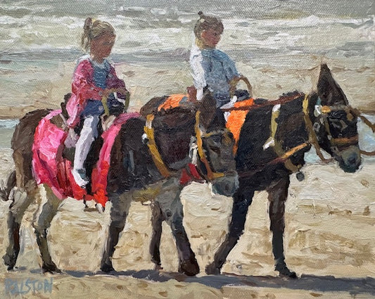 Two dark brown beach donkeys carrying two best friends at the seaside