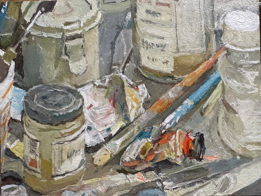 A still life oil painting study, looking at old paint tubes and turps bottles, brushes 