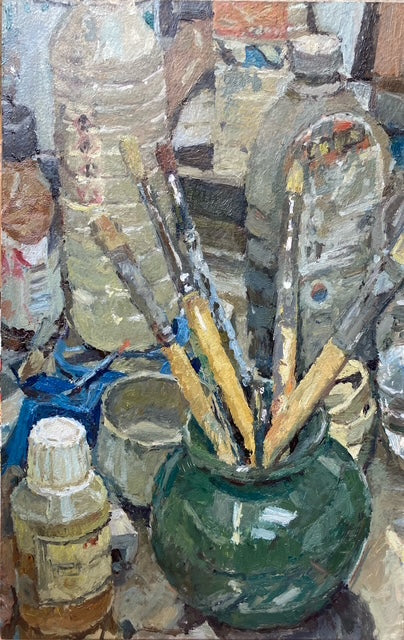 An impressionistic painting depicting an artist's studio scene with paintbrushes in a green pot, surrounded by bottles and containers.