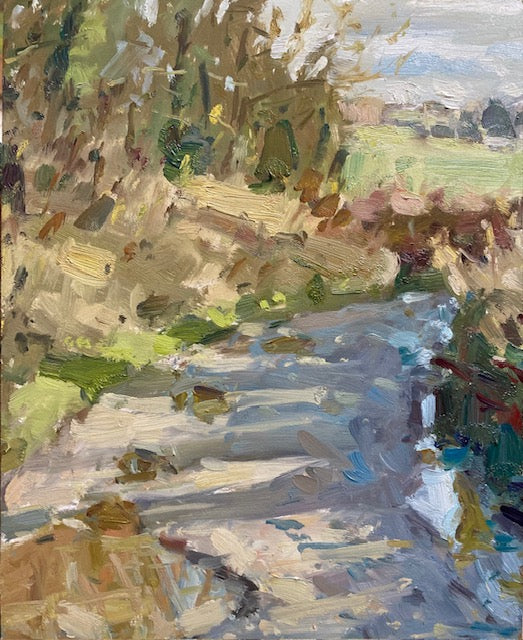 Impressionistic landscape painting of a sunlit path or stream running through a wooded area, rendered in visible brushstrokes of beige, green, blue, brown, and white. A small oil painting on Mowbreck Lane with shadows on the right side and Green fields in the background