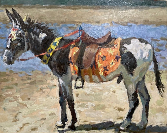 An impressionistic painting of a donkey standing on a sandy beach in Blackpool with blue water in the background. The donkey is wearing a brown saddle and an orange patterned blanket.