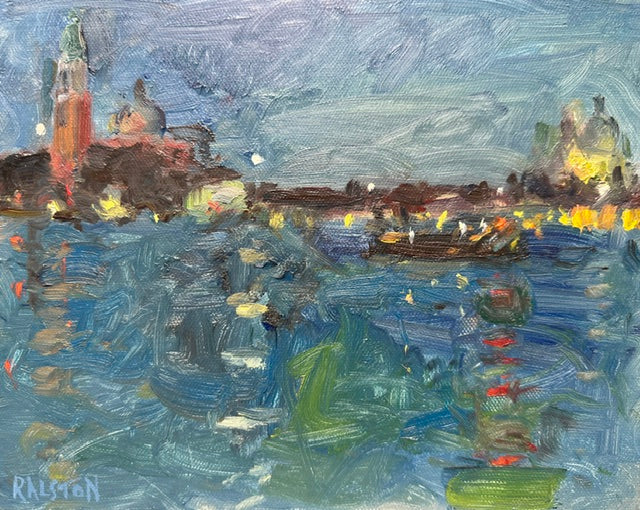A Nocturnal painting looking across the Grand Canal in Venice towards San Giorgio Maggiore and the Salute. Yellow and white lights flicker in the night with the whole scene a very lush deep blue and one boat crossing; a red light reflecting from it in the water