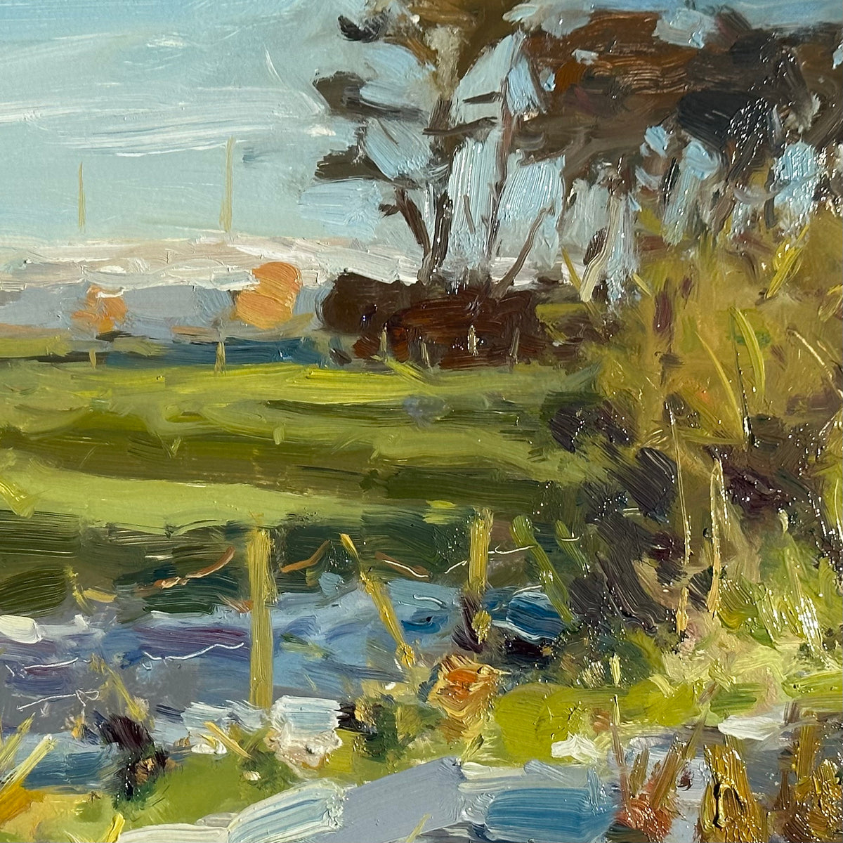 An impressionistic landscape painting in wesham with the distant snow capped pennine hills...featuring textured brushstrokes in green, yellow, brown, blue, and white, depicting trees, grasses, and a field.