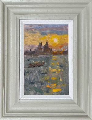 Framed impressionist landscape painting featuring a golden sun over a reflective body of water with Salute buildings in the distance, set within a light gray frame and white mat.