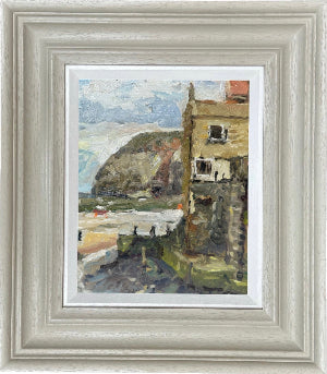 Framed impressionist landscape painting of a coastal village in Staithes west Yorkshire. penny nab is in the distance and a  prominent building, hillside, and sea, set in a hand made wooden frame.